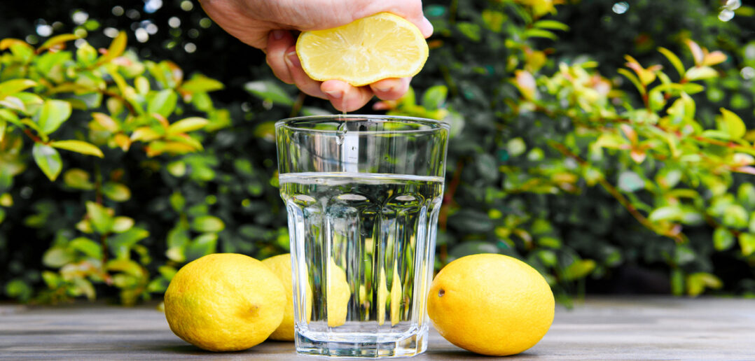 Squeezing a lemon juice into the water